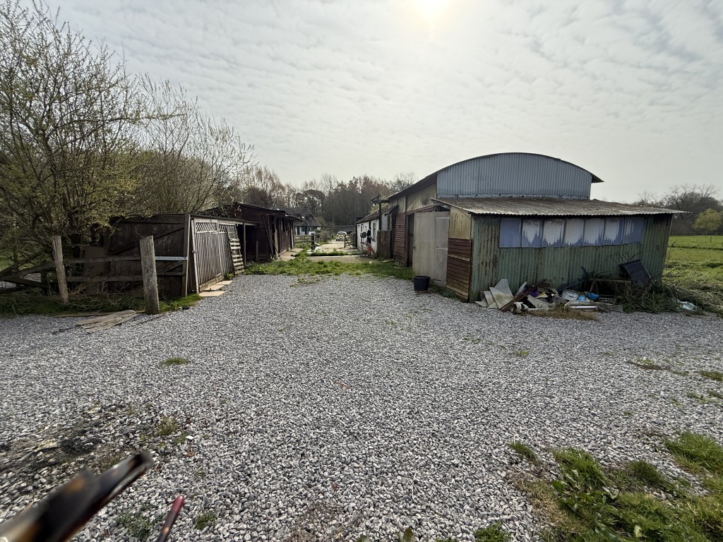 Lot: 144 - DETACHED COTTAGE WITH OUTBUILDING AND STABLES ON A SITE MEASURING OVER SIX ACRES - General view of loose boxes and stables